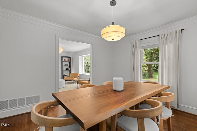 1706 Rangecrest Rd, Raleigh, NC 27612 - dining space with crown molding, plenty of natural light, wood finished floors, and baseboards