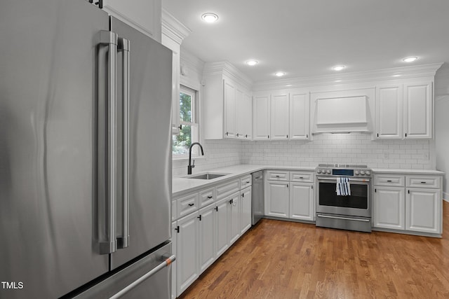1706 Rangecrest Rd, Raleigh, NC 27612 - kitchen with premium appliances, custom exhaust hood, a sink, light countertops, and light wood-type flooring