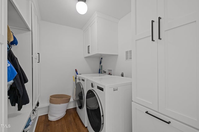 1706 Rangecrest Rd, Raleigh, NC 27612 - washroom featuring cabinet space, dark wood-style flooring, and washer and clothes dryer