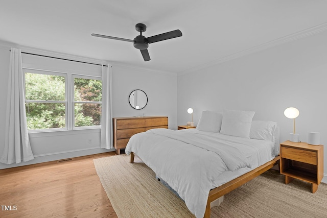 1706 Rangecrest Rd, Raleigh, NC 27612 - bedroom featuring crown molding, baseboards, light wood-style flooring, and ceiling fan