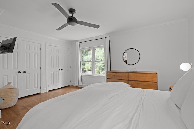 1706 Rangecrest Rd, Raleigh, NC 27612 - bedroom featuring crown molding, multiple closets, wood finished floors, and ceiling fan