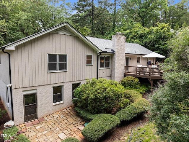 1706 Rangecrest Rd, Raleigh, NC 27612 - back of property featuring a patio area, a deck, and a chimney