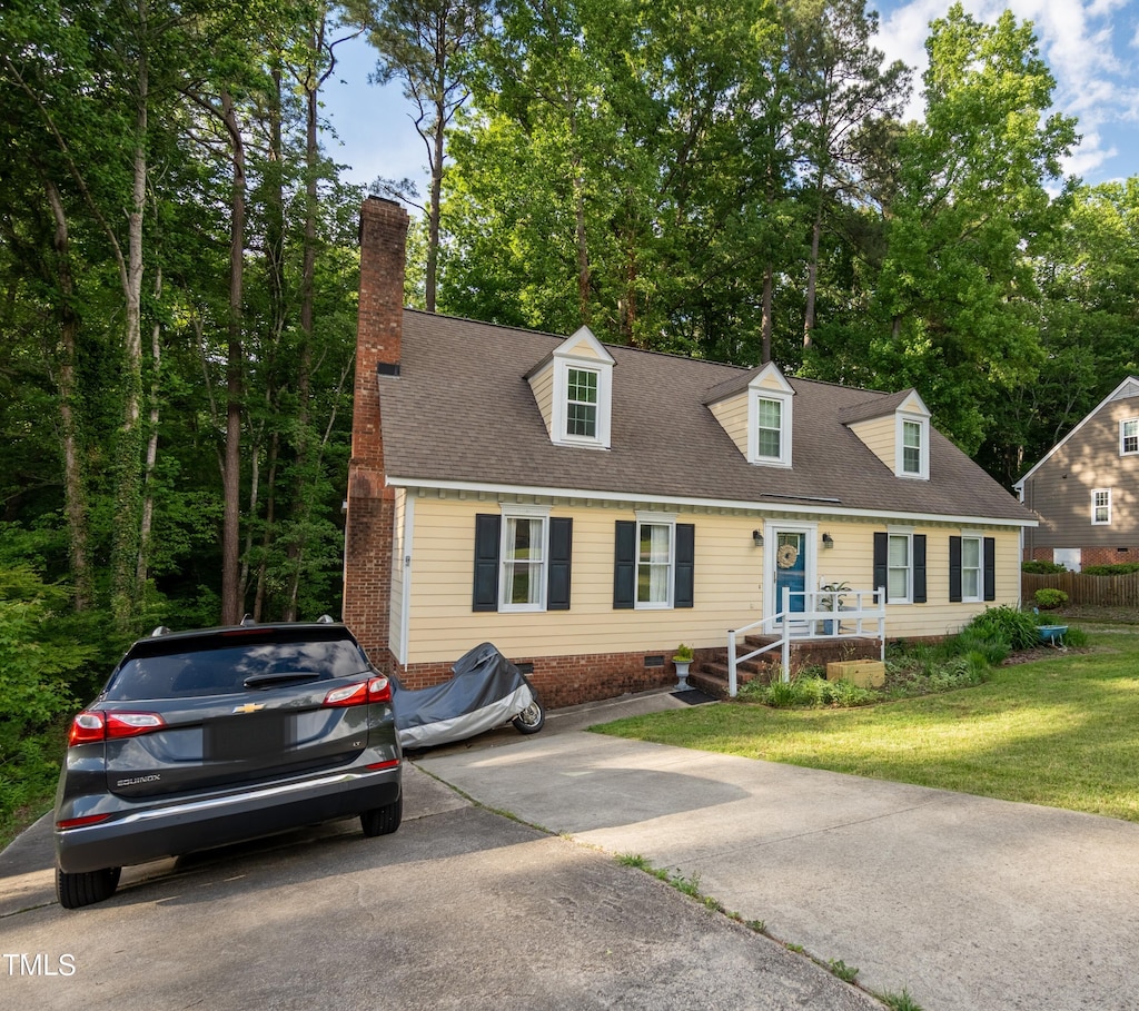cape cod house with a front yard, a chimney, crawl space, and a shingled roof