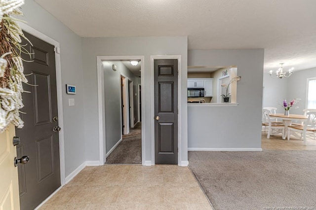 2068 Tingen Rd, Broadway, NC 27505 - foyer entrance featuring a chandelier, light carpet, baseboards, and light tile patterned floors