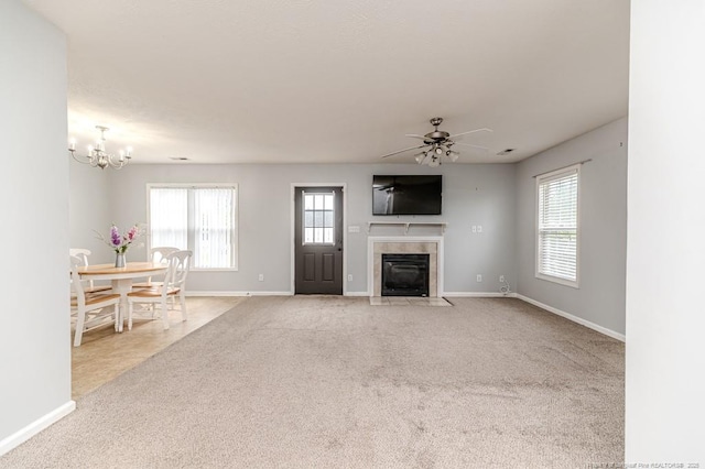2068 Tingen Rd, Broadway, NC 27505 - living area featuring a tiled fireplace, baseboards, a ceiling fan, carpet flooring, and a chandelier