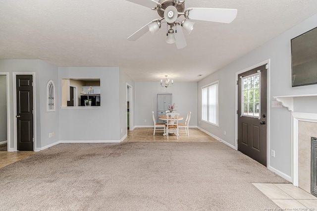 2068 Tingen Rd, Broadway, NC 27505 - unfurnished living room featuring light colored carpet, a tile fireplace, ceiling fan, and baseboards