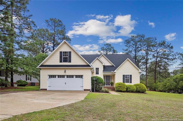 traditional-style home featuring a front lawn, driveway, and a garage