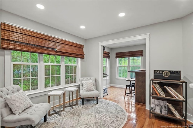 sitting room with wood finished floors, baseboards, and recessed lighting