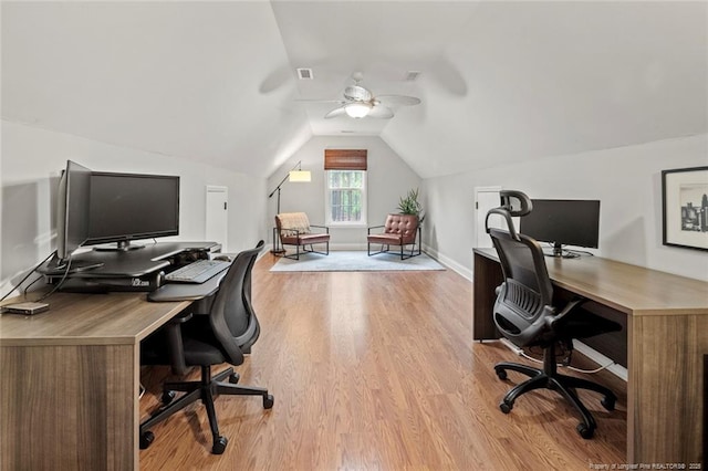 office area featuring ceiling fan, light wood-style flooring, vaulted ceiling, and baseboards