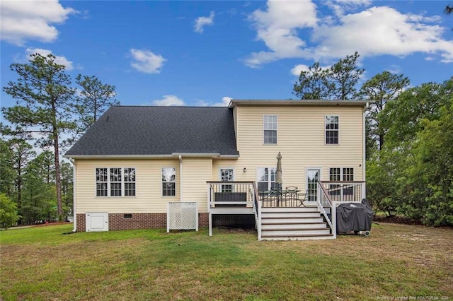 rear view of property with a wooden deck, a lawn, a shingled roof, and crawl space