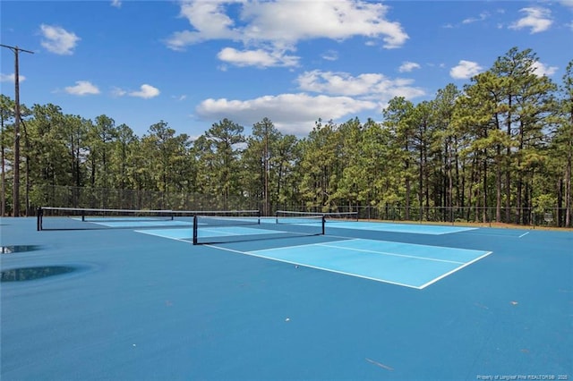 view of tennis court featuring fence