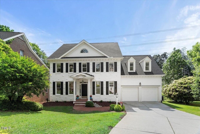 view of front of property with driveway, a front yard, an attached garage, and a shingled roof
