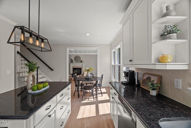 kitchen with open shelves, stainless steel dishwasher, tasteful backsplash, white cabinetry, and ornamental molding