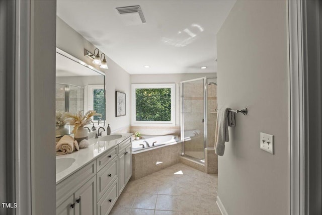bathroom featuring a shower stall, double vanity, a garden tub, and tile patterned floors