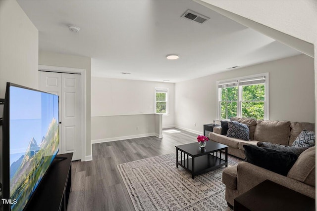 living room featuring wood finished floors and baseboards