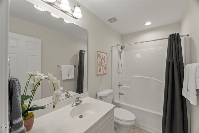 bathroom with toilet, vanity, shower / bath combo, and tile patterned floors