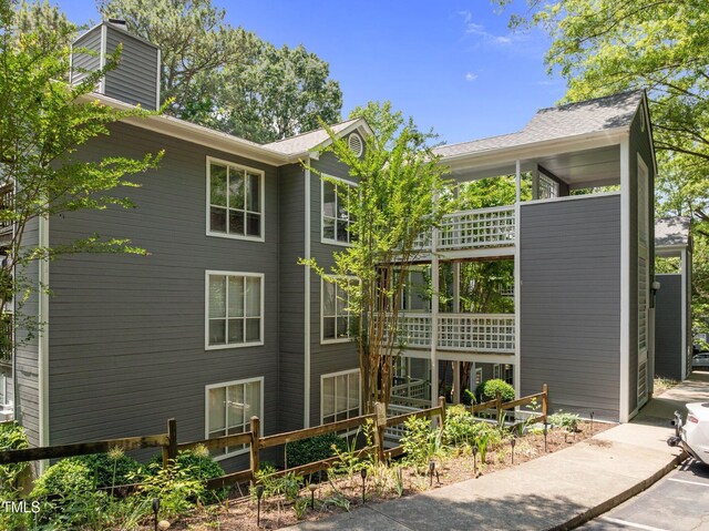 4631 Timbermill Ct Unit 203, Raleigh, NC 27612 - view of property exterior with a chimney