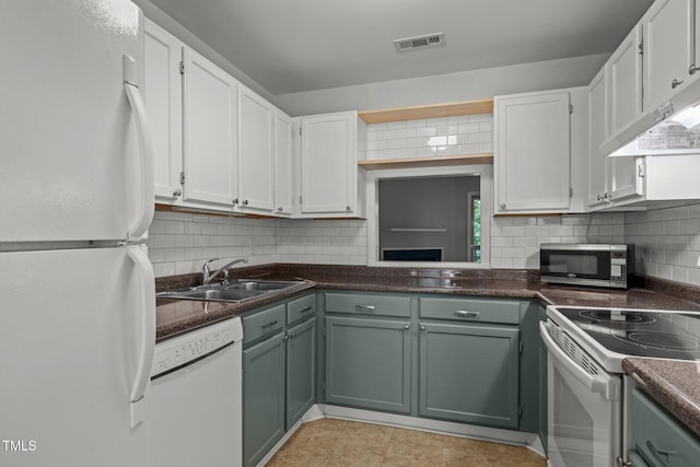 4631 Timbermill Ct Unit 203, Raleigh, NC 27612 - kitchen with white appliances, a sink, tasteful backsplash, and dark countertops