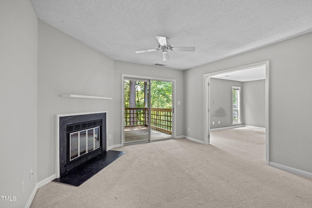 4631 Timbermill Ct Unit 203, Raleigh, NC 27612 - unfurnished living room featuring a fireplace with flush hearth, healthy amount of natural light, carpet, baseboards, and a textured ceiling
