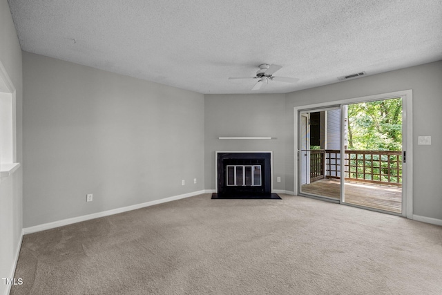 4631 Timbermill Ct Unit 203, Raleigh, NC 27612 - unfurnished living room featuring a fireplace with flush hearth, carpet flooring, a textured ceiling, baseboards, and ceiling fan