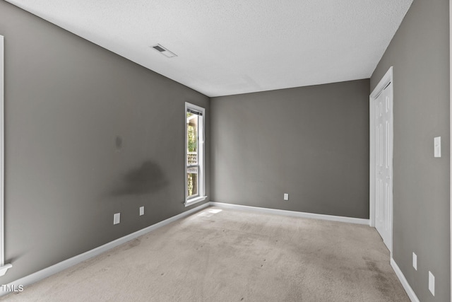 4631 Timbermill Ct Unit 203, Raleigh, NC 27612 - carpeted spare room featuring a textured ceiling and baseboards