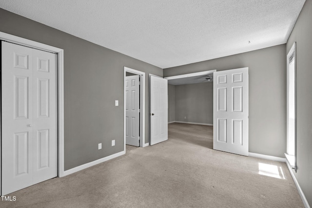 4631 Timbermill Ct Unit 203, Raleigh, NC 27612 - unfurnished bedroom with carpet floors, baseboards, and a textured ceiling