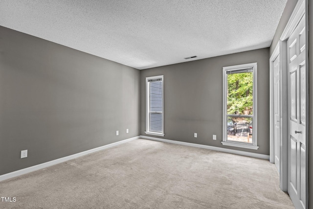 4631 Timbermill Ct Unit 203, Raleigh, NC 27612 - unfurnished bedroom featuring carpet flooring, a textured ceiling, and baseboards