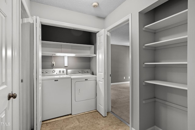 4631 Timbermill Ct Unit 203, Raleigh, NC 27612 - laundry room with washing machine and dryer, a textured ceiling, and baseboards