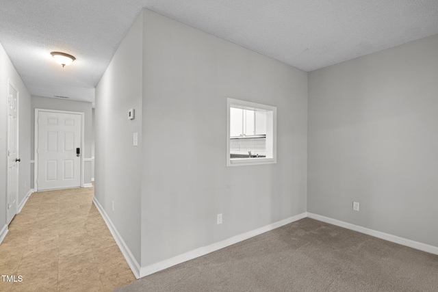 4631 Timbermill Ct Unit 203, Raleigh, NC 27612 - empty room with baseboards and a textured ceiling