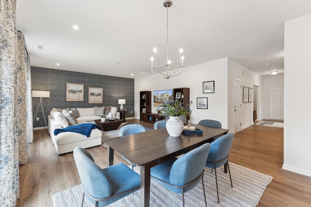 27 Cribbs Ln, Middlesex, NC 27557 - dining space with a chandelier, baseboards, wood finished floors, and an accent wall