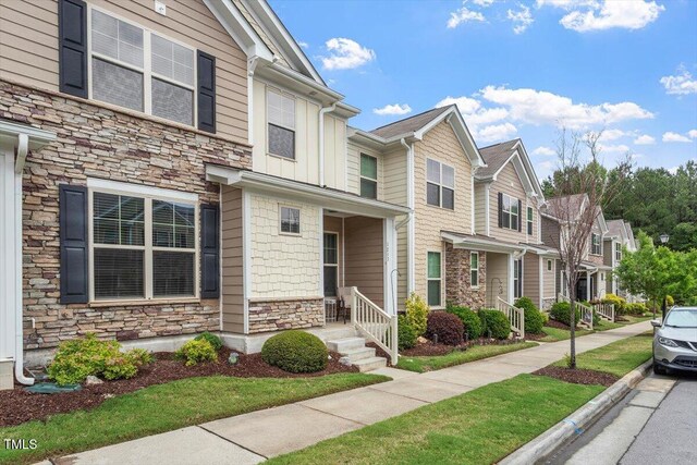 1213 Treetop Meadow Ln, Wake Forest, NC 27587 - view of property with stone siding, a residential view, and board and batten siding