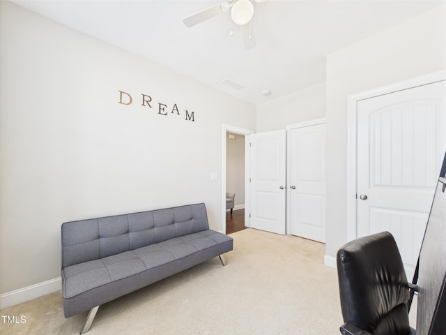 office area featuring light colored carpet, ceiling fan, and baseboards