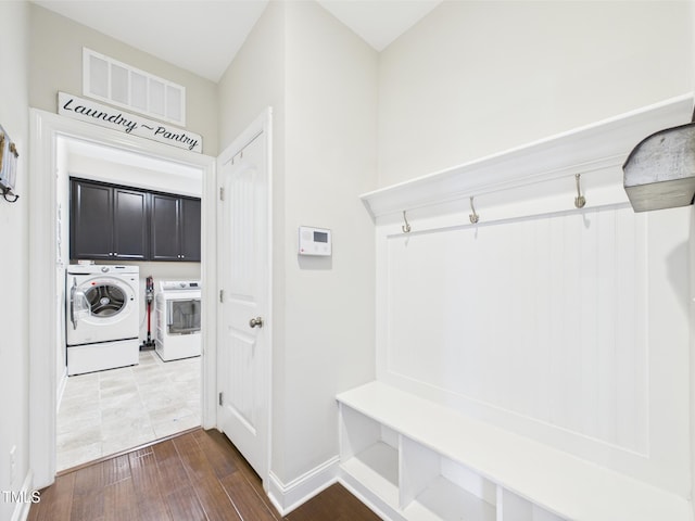 mudroom featuring washer and clothes dryer, dark wood finished floors, and baseboards