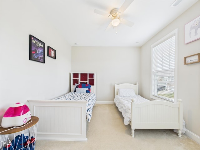 bedroom with carpet flooring, multiple windows, and baseboards