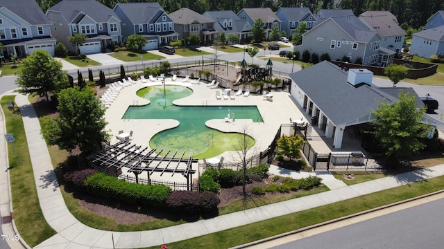 aerial perspective of suburban area featuring a pool