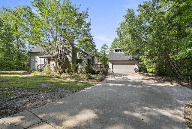 mid-century inspired home with driveway and a garage