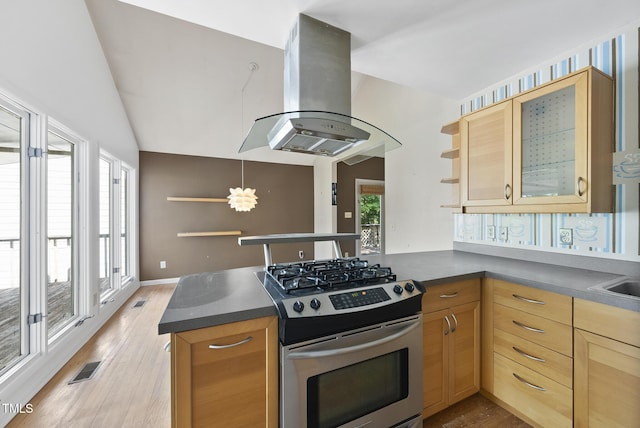 kitchen featuring gas range, open shelves, island range hood, a peninsula, and light wood-type flooring