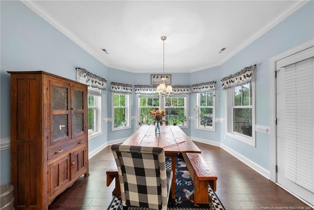 dining room featuring dark wood-type flooring, baseboards, crown molding, and a chandelier