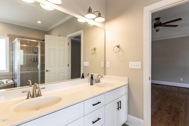 120 Gentle Rain Dr, Garner, NC 27529 - bathroom featuring a ceiling fan, a stall shower, ornamental molding, double vanity, and wood finished floors