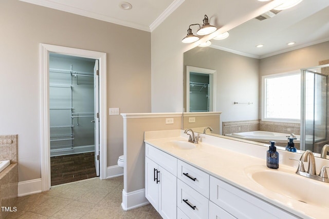 120 Gentle Rain Dr, Garner, NC 27529 - bathroom featuring tile patterned floors, ornamental molding, a walk in closet, a stall shower, and double vanity