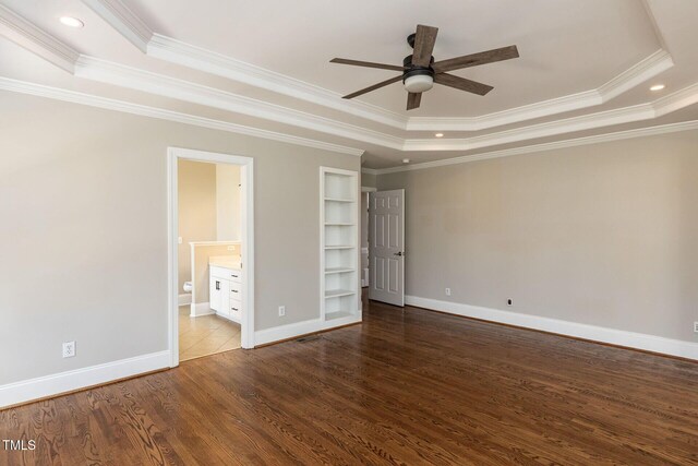 120 Gentle Rain Dr, Garner, NC 27529 - unfurnished bedroom featuring a raised ceiling, crown molding, dark wood-type flooring, baseboards, and recessed lighting