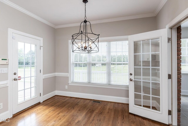 120 Gentle Rain Dr, Garner, NC 27529 - doorway to outside featuring a chandelier, wood finished floors, plenty of natural light, baseboards, and ornamental molding