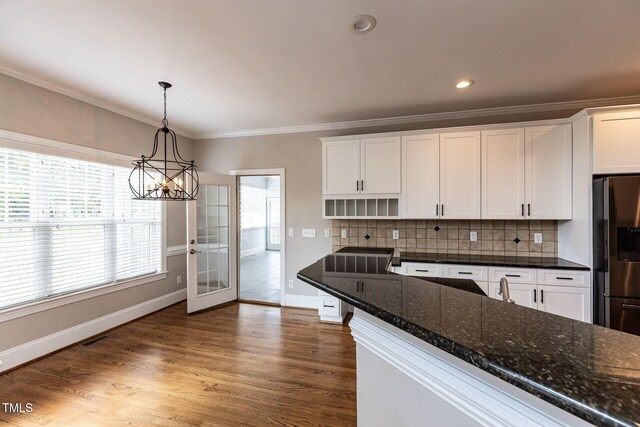 120 Gentle Rain Dr, Garner, NC 27529 - kitchen featuring stainless steel refrigerator with ice dispenser, white cabinetry, crown molding, a chandelier, and baseboards