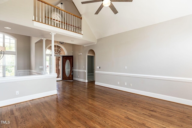 120 Gentle Rain Dr, Garner, NC 27529 - unfurnished living room featuring high vaulted ceiling, a ceiling fan, ornate columns, wood finished floors, and arched walkways