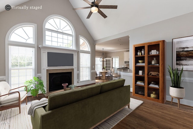 120 Gentle Rain Dr, Garner, NC 27529 - living room featuring wood finished floors, ceiling fan, a fireplace, high vaulted ceiling, and a chandelier