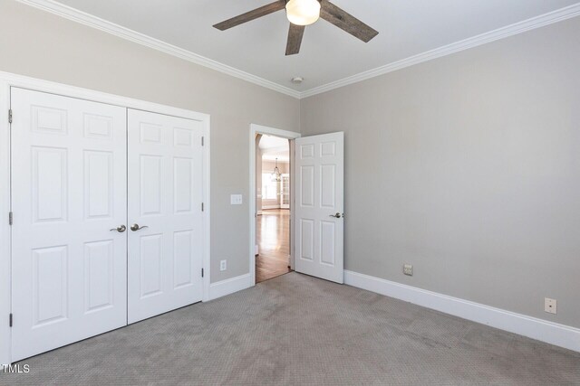 120 Gentle Rain Dr, Garner, NC 27529 - unfurnished bedroom with ornamental molding, carpet, baseboards, a closet, and a ceiling fan