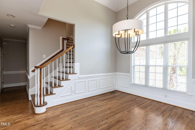 120 Gentle Rain Dr, Garner, NC 27529 - staircase with wood finished floors, a chandelier, and ornamental molding