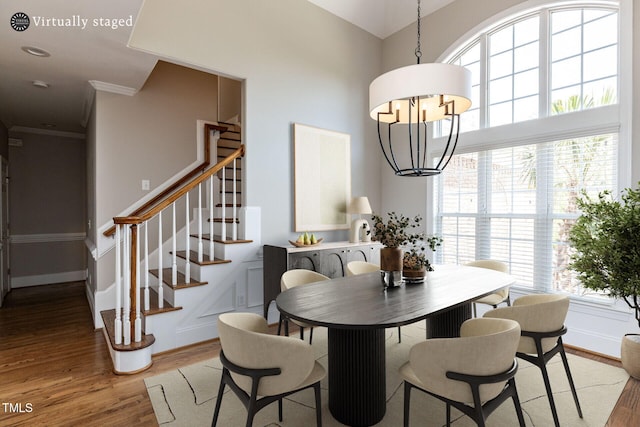 120 Gentle Rain Dr, Garner, NC 27529 - dining area with light wood-style floors, stairs, a chandelier, plenty of natural light, and crown molding