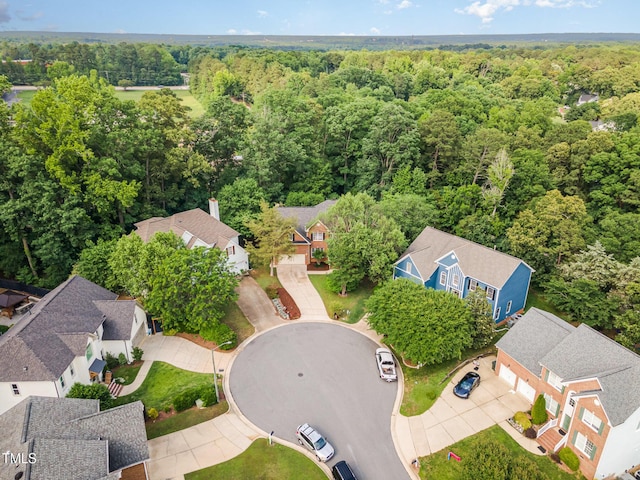 aerial view of residential area with a heavily wooded area