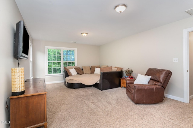 living room featuring carpet flooring and baseboards